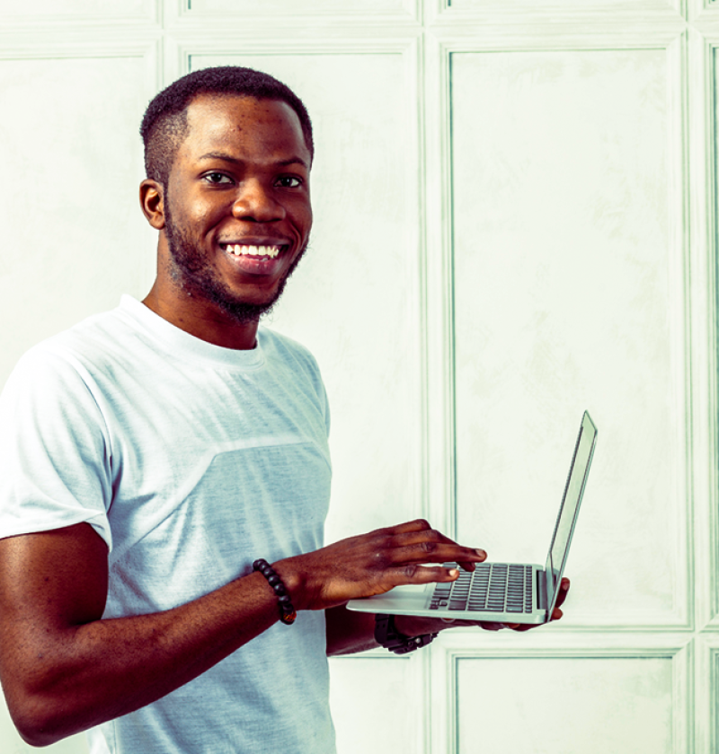 african-young-man-holding-laptop
